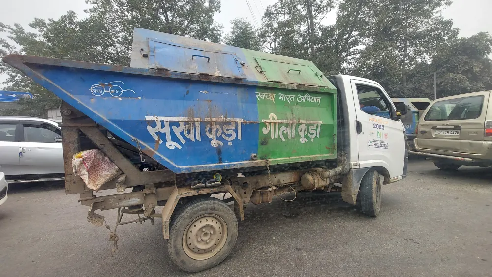 Segregated door-to-door waste collection truck in India with separate dry and wet waste compartments