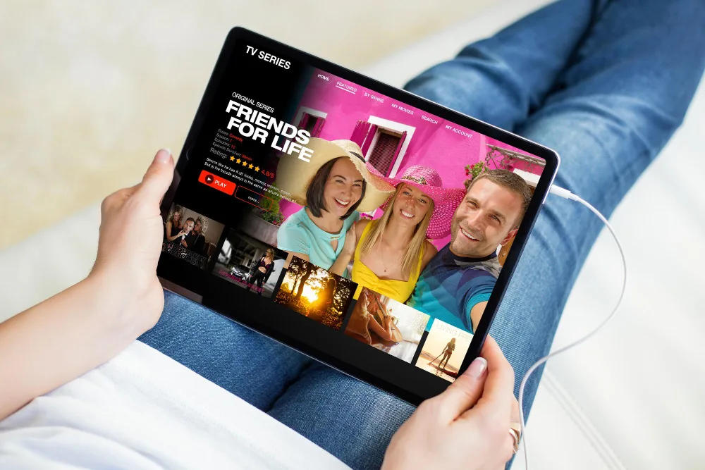 Viewer browsing featured shows and on-demand series on a tablet