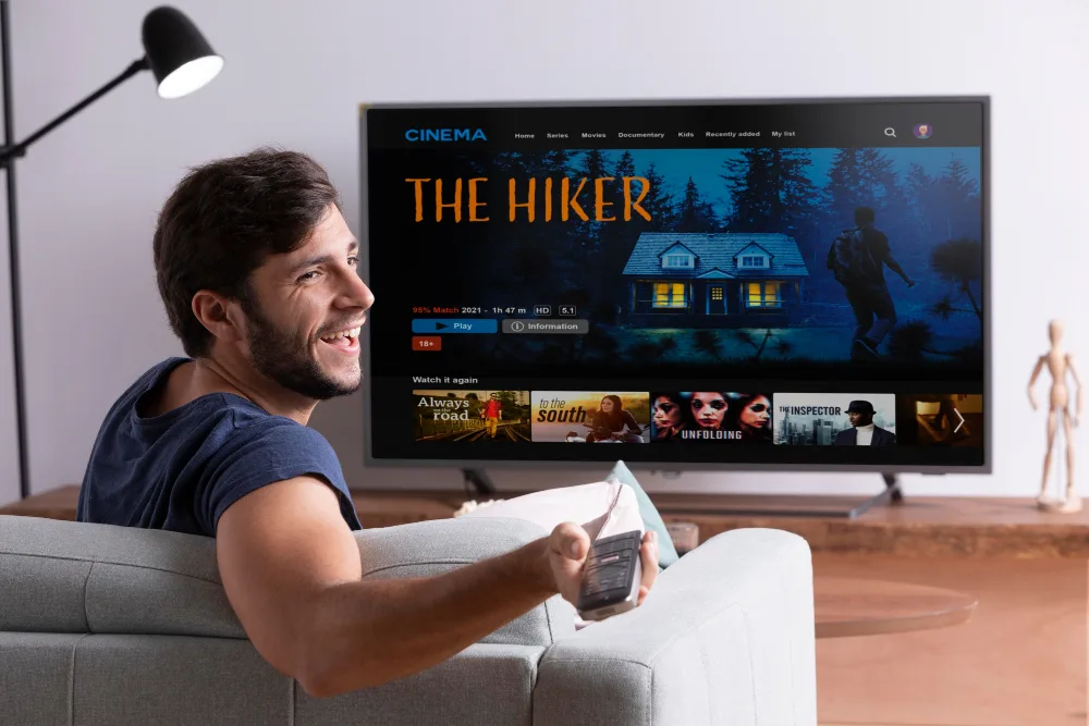 Viewer streaming a film on a large smart TV in a living room