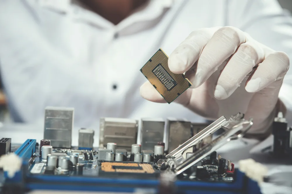 Engineer fitting a processor onto a circuit board